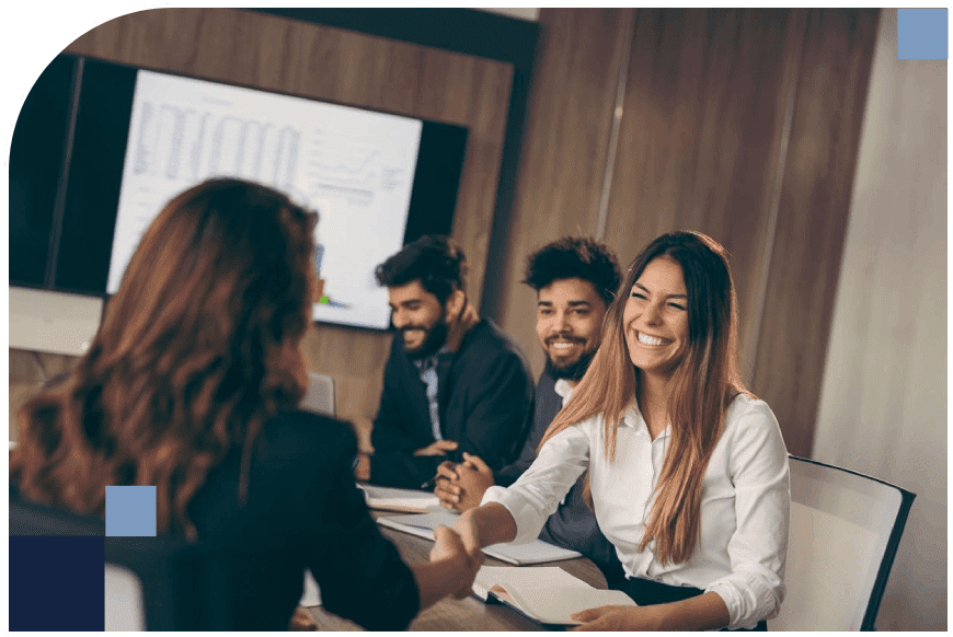 A group of people shaking hands in a meeting room during a talent sourcing event.