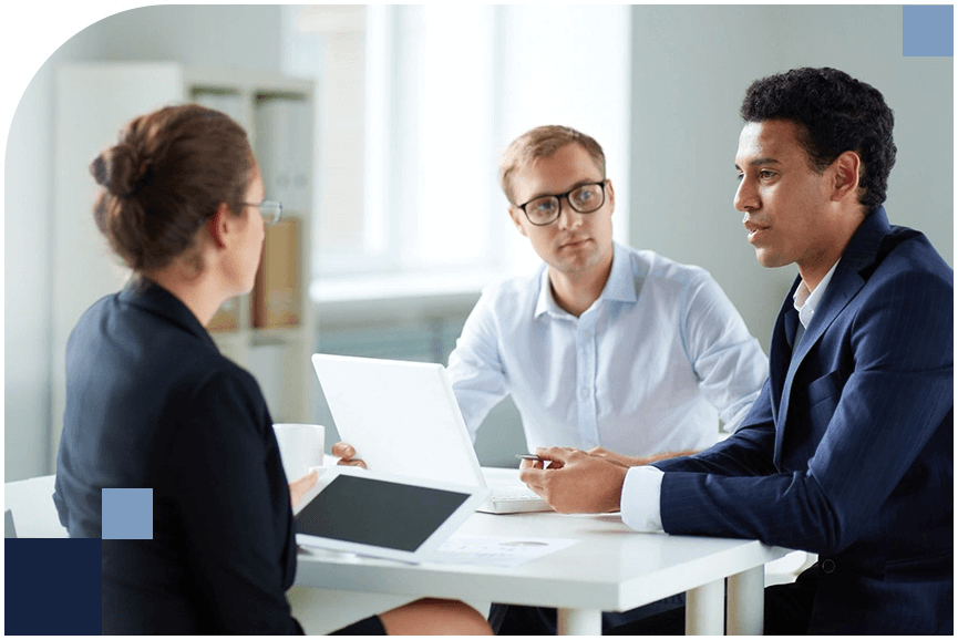 Recruitment Solutions: A group of people having a conversation at a table.